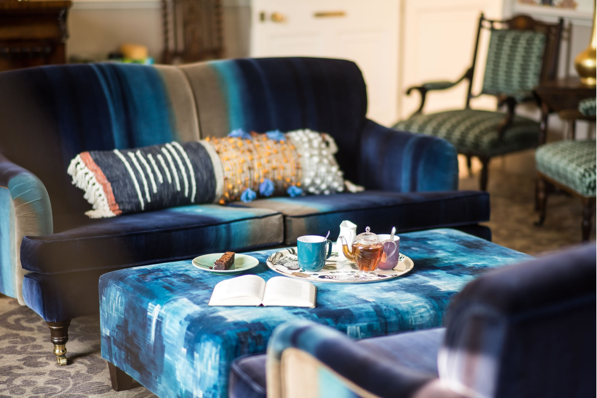 Tea served on the coffee table in the Combe Grove Drawing room, blue striped sofas