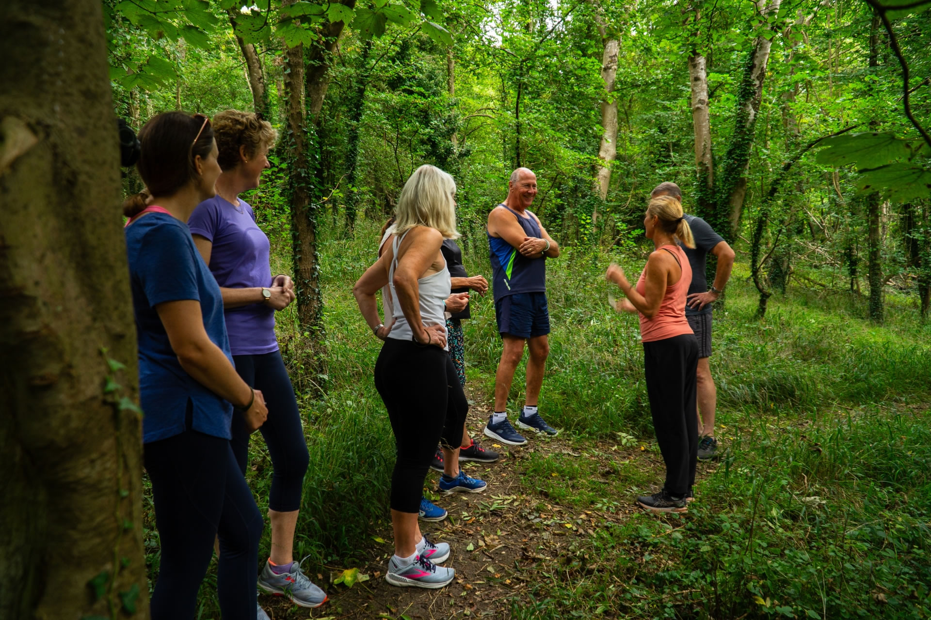 Clients with a movement coach in the woods at Combe Grove