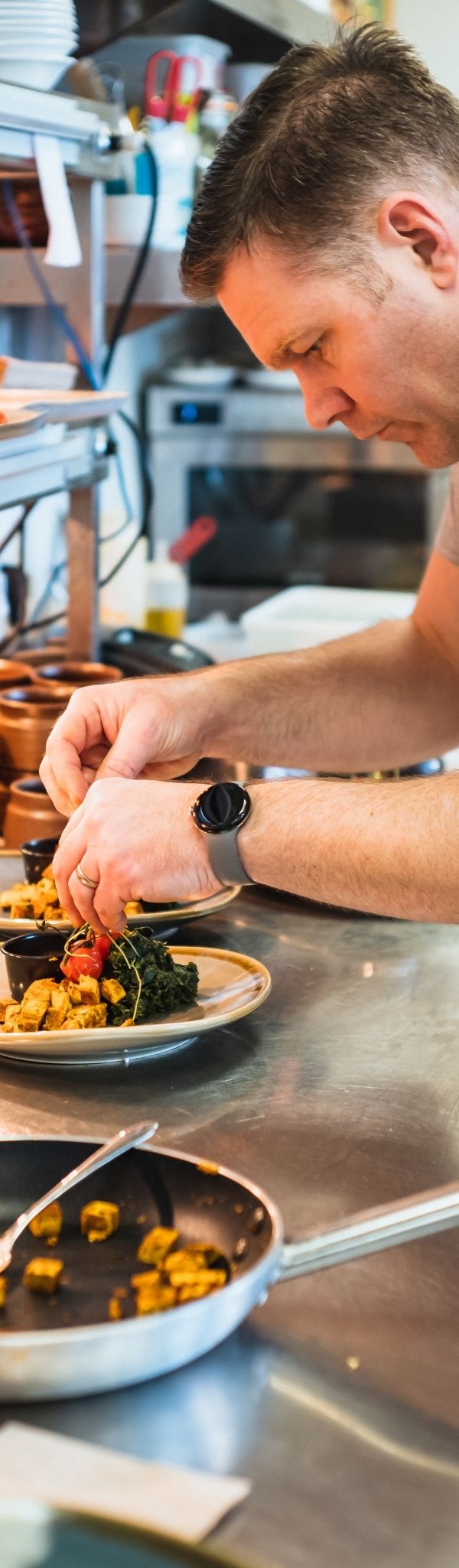 Chef preparing dish at Combe Grove
