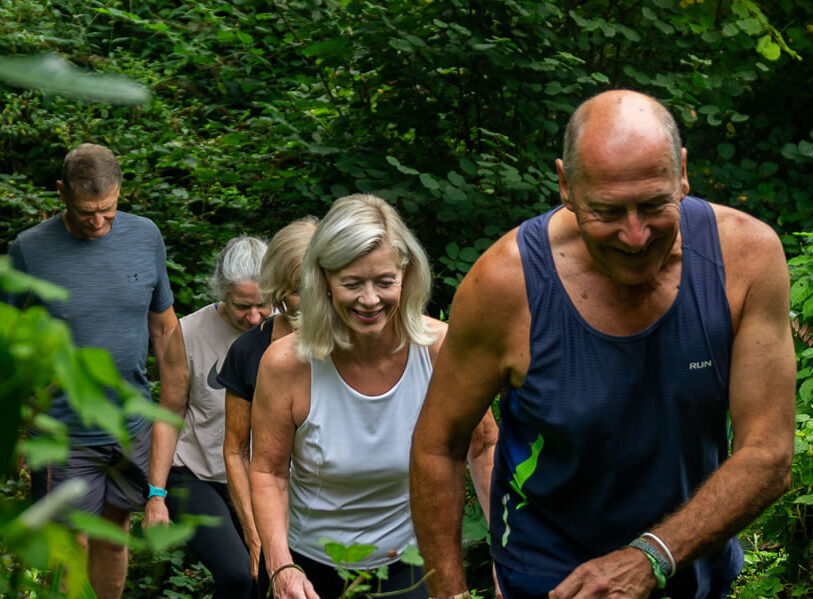 Clients on a woodland walk at Combe Grove